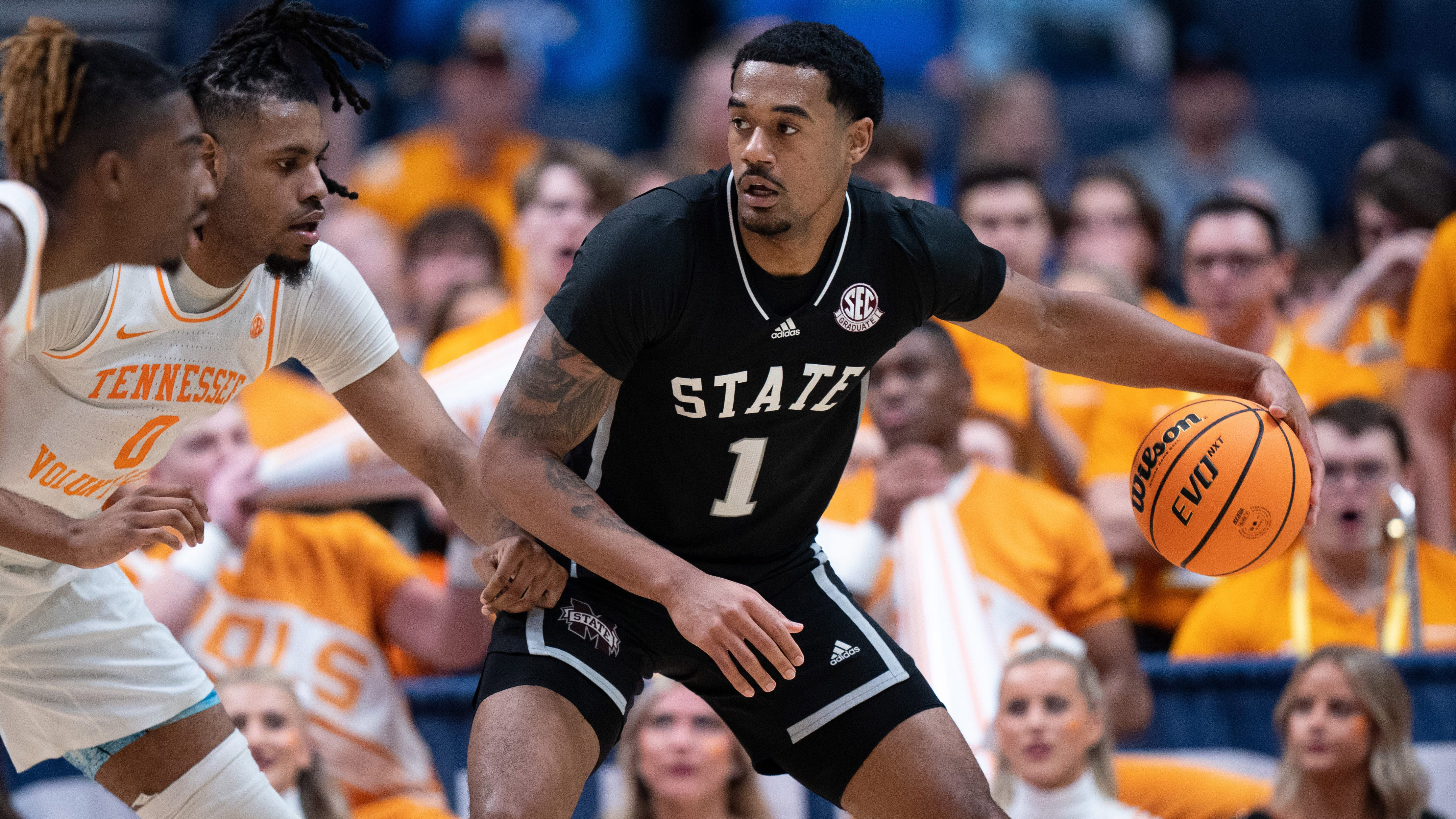 Mississippi State Bulldogs forward Tolu Smith drives against Tennessee Volunteers forward Jonas Aidoo.